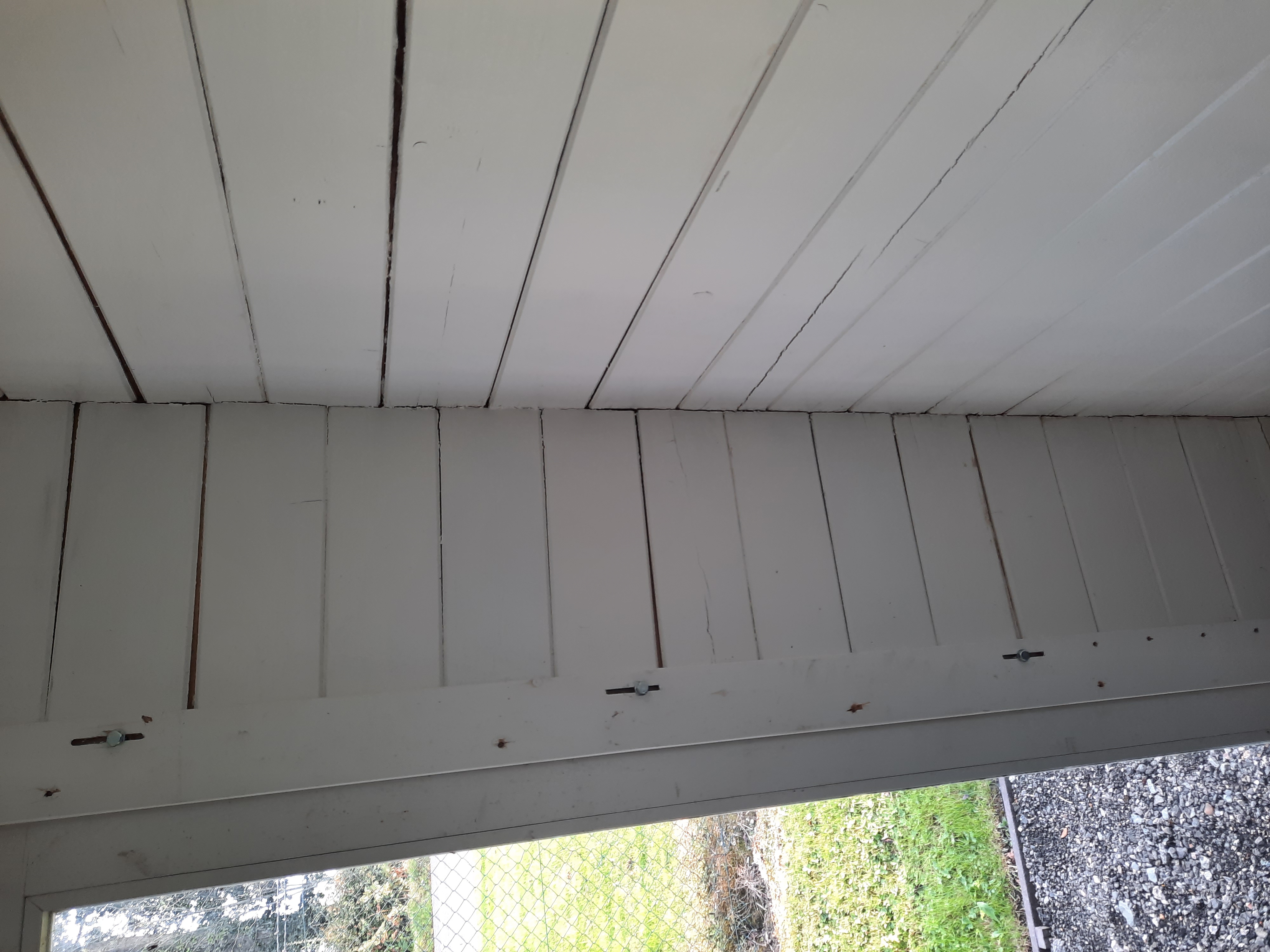 Gaps in log cabin walls caused by over-tightening fixings in wind bracing or slotted windows / door trims